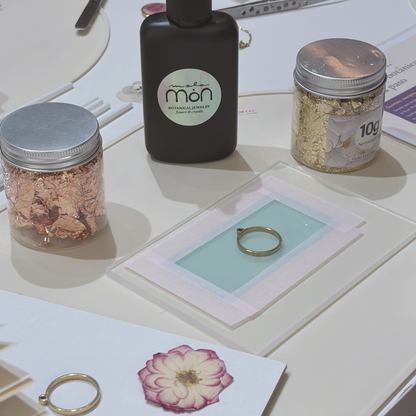 Botanical jewellery workshop materials: UV resin, gold leaf, pressed flowers and a gold bezel, in Barcelona